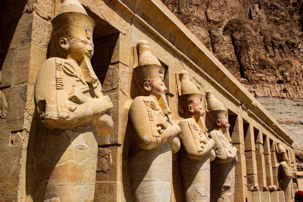 Row of ancient Egyptian Osiris statues at Hatshepsut Temple near Deir el-Bahari, a must-see sight adjacent to the Deir el-Medina excursion on Luxor's West Bank