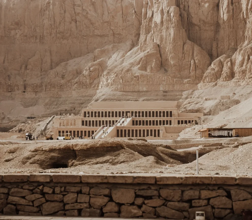 Panoramic view of the Mortuary Temple of Hatshepsut against limestone cliffs, a key landmark near the Deir el-Medina excursion on the West Bank of Luxor, Egypt