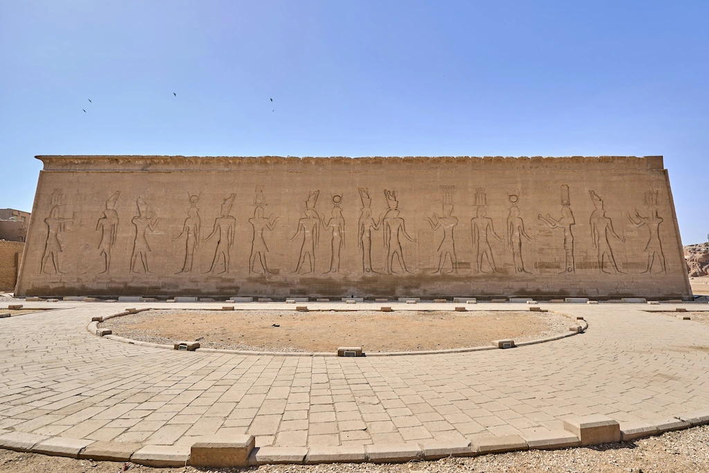 Temple of Edfu Egypt back wall relief carvings of Egyptian gods and ritual basin