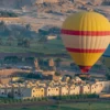 Hot air balloon Egypt Luxor ascending at dawn over the Valley of the Kings