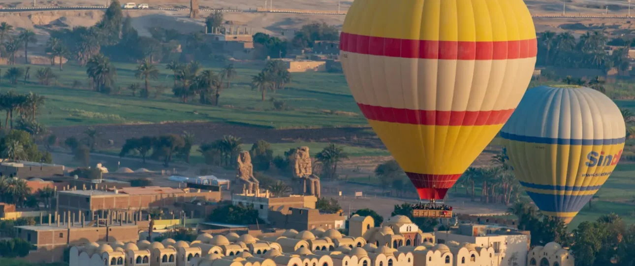 Hot air balloon Egypt Luxor ascending at dawn over the Valley of the Kings