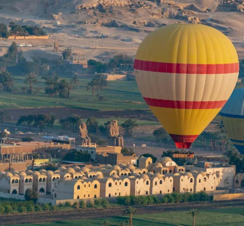 Hot air balloon Egypt Luxor ascending at dawn over the Valley of the Kings