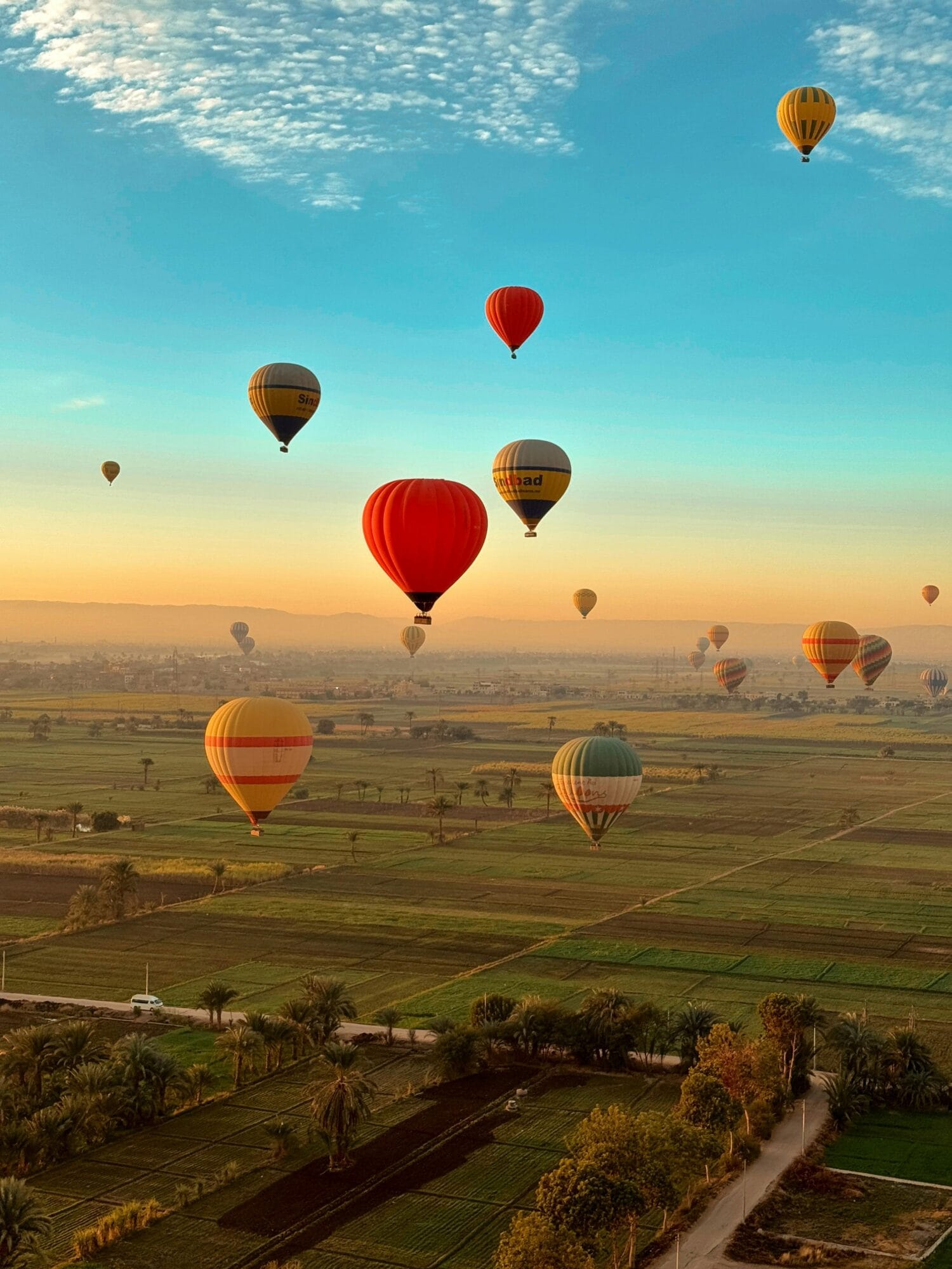 Hot air balloon Egypt Luxor ascending at dawn over the Valley of the Kings