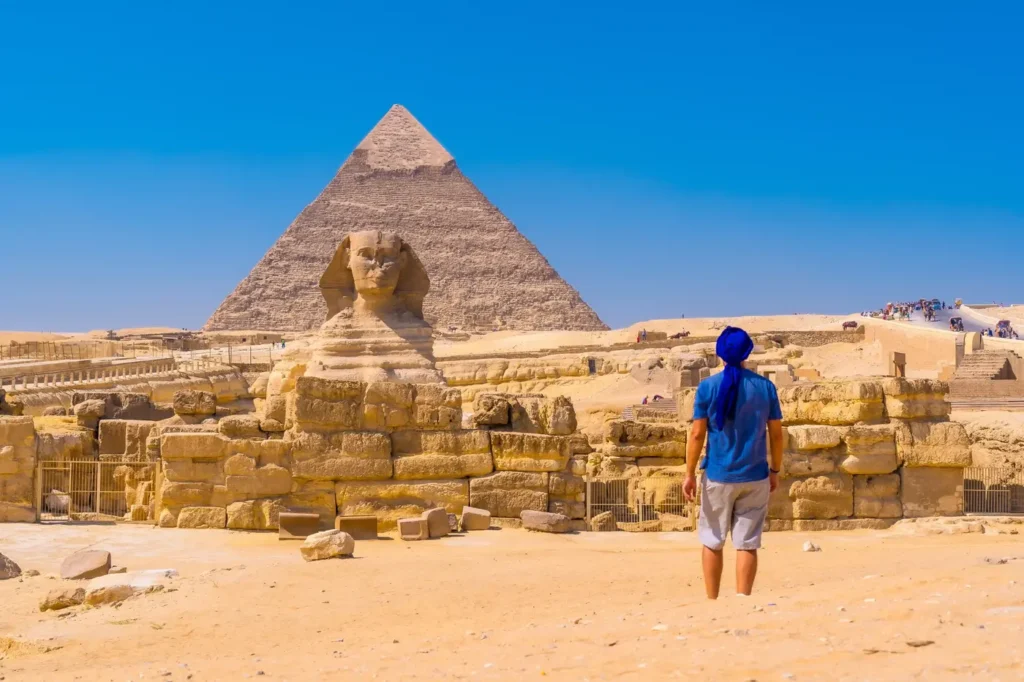 Luxury Egypt Tours - Solo traveler approaching the Great Sphinx of Giza during a quiet early-morning visit