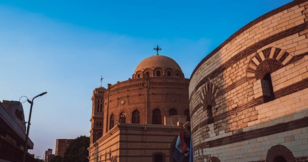 Coptic Cairo Egypt hanging church dome and cross against blue sky