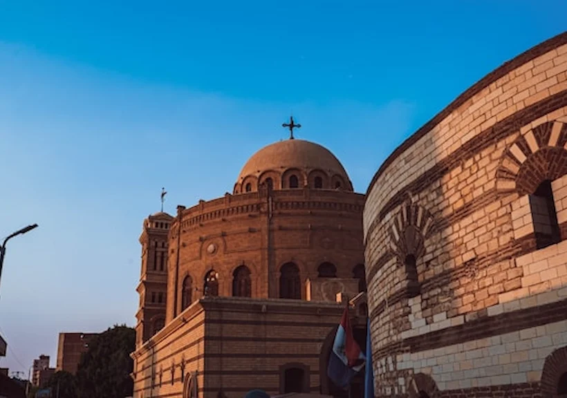 Coptic Cairo Egypt hanging church dome and cross against blue sky