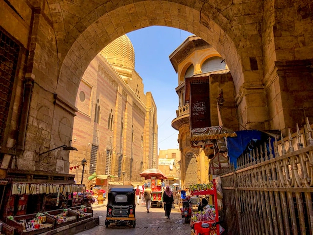 Stone archway framing a mosque along the medieval alleys of Islamic Cairo