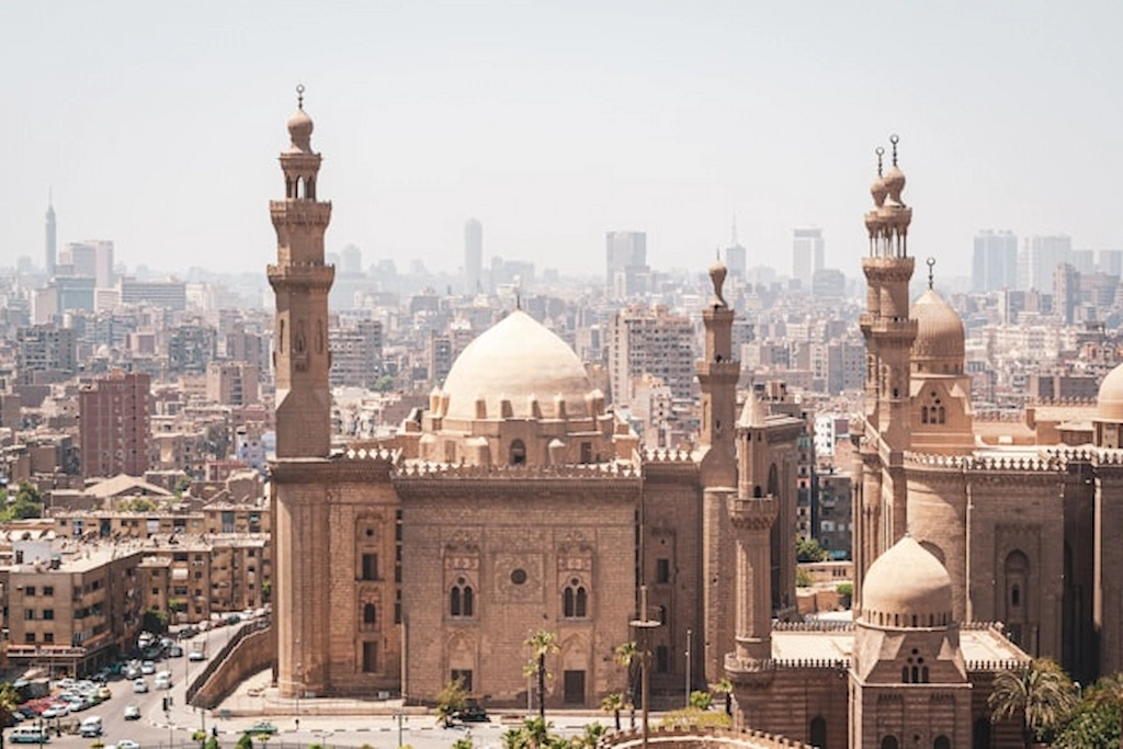 Skyline view over the medieval alleys of Islamic Cairo dense with mosque minarets