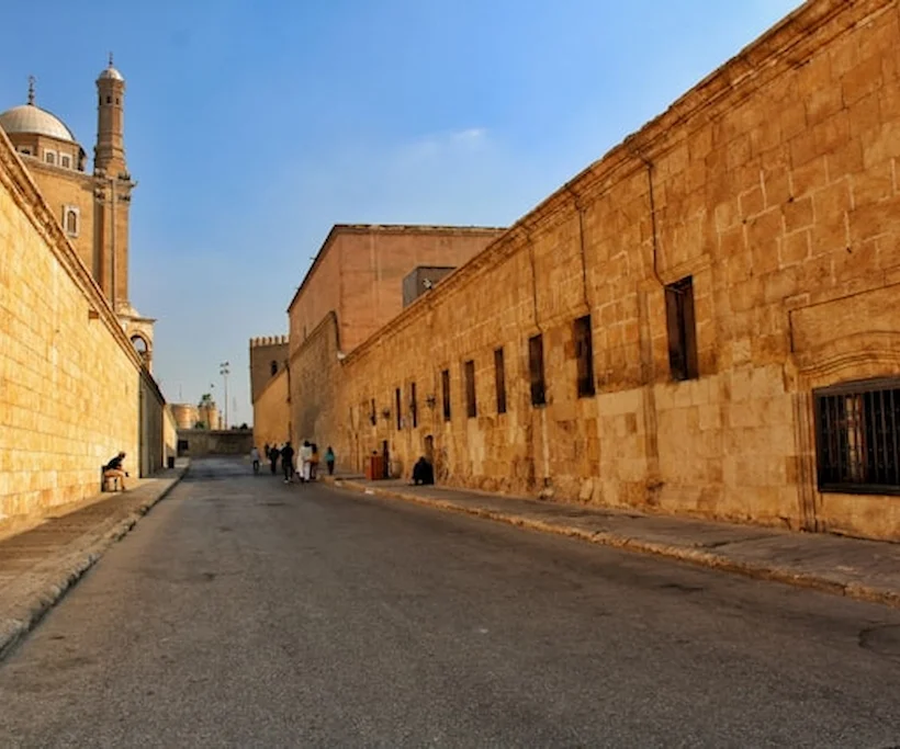 Medieval alleys of Islamic Cairo lined with ancient stone walls near a mosque