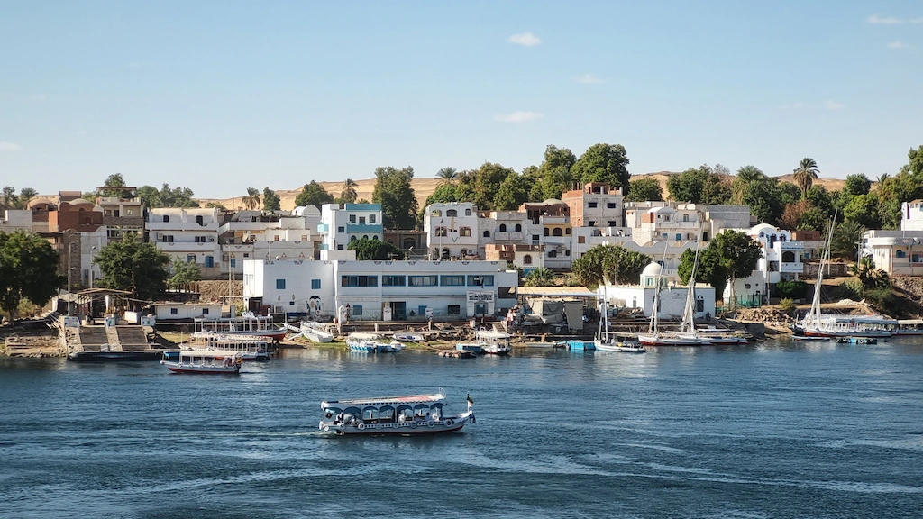Cruise boats and ferries docked along the Nile River near Aswan, a floating base for eclipse week - Egypt Solar Eclipse Tour