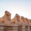 Ram-headed sphinx avenue at Karnak, ancient capital of Egypt at sunset