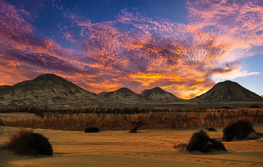 Volcanic black hills scattered across the Black Desert near Bahariya