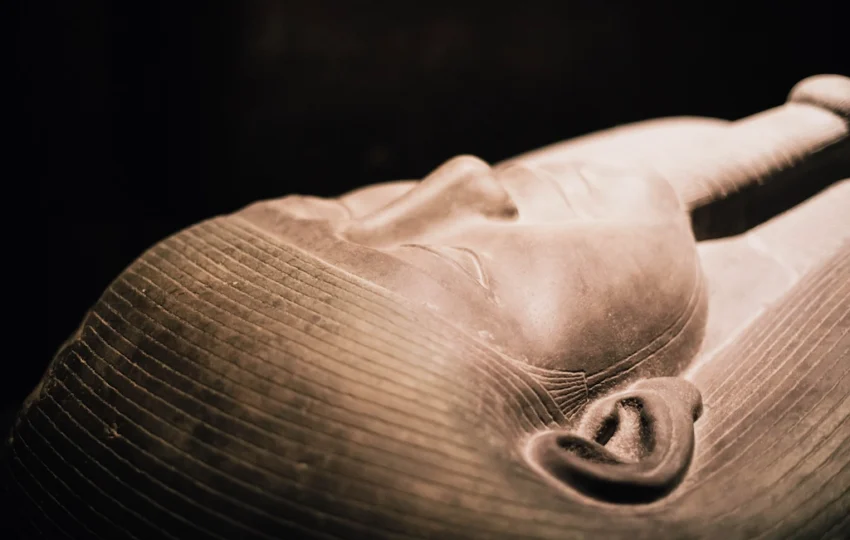 What Is an Egyptian Sarcophagus? Close-up of a carved sarcophagus lid face showing traditional Egyptian funerary artistry