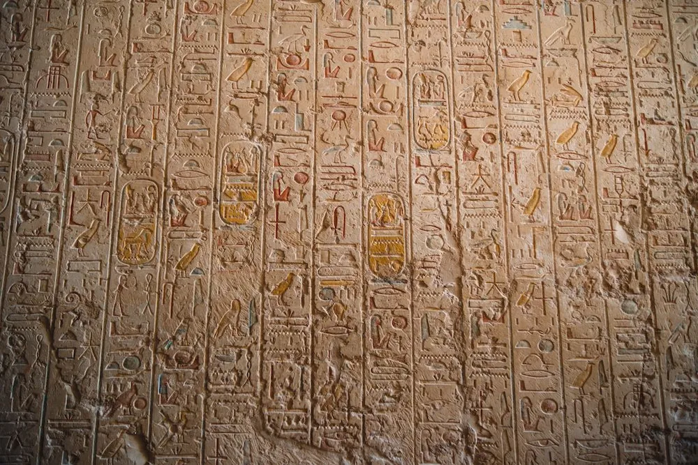 Ancient Egyptian hieroglyphs carved on a temple wall, part of the medical and magical texts tied to Imhotep's legacy - egypt wizard doctor tomb saqqara