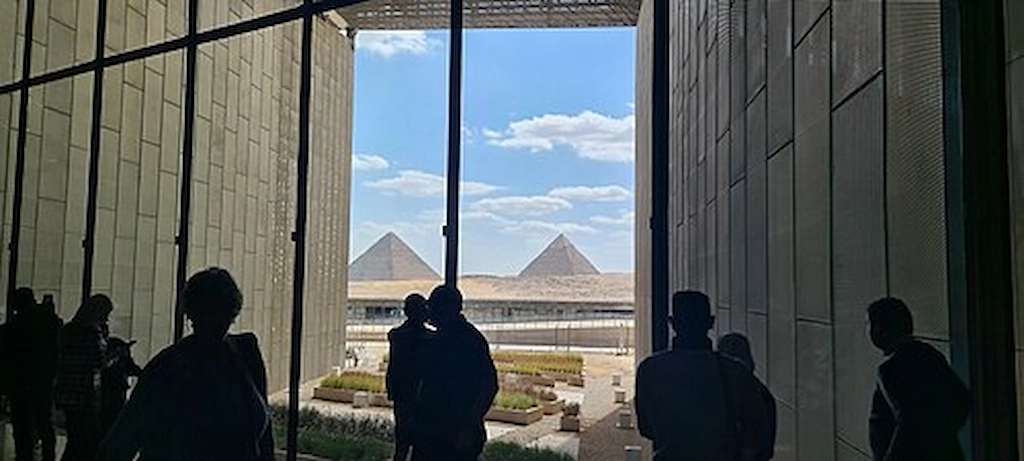 Nefertiti Tomb Egypt - View of the Pyramids of Giza from inside the Grand Egyptian Museum, home to expanding Amarna-era displays