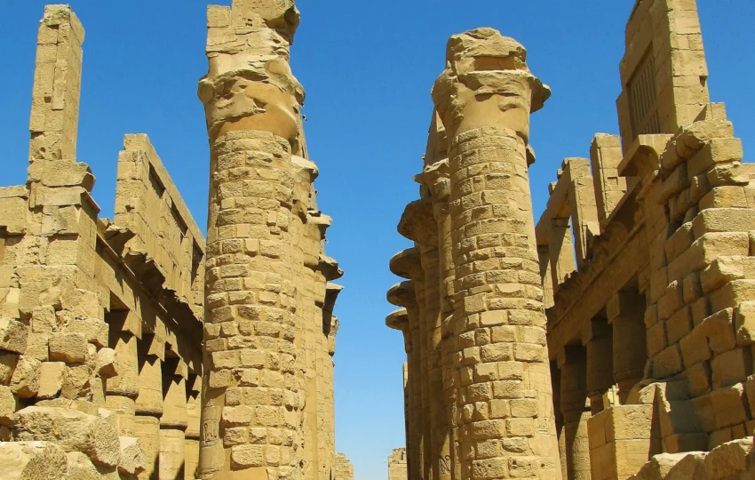 Standing among the 134 columns of the Great Hypostyle Hall on the Karnak temple tour