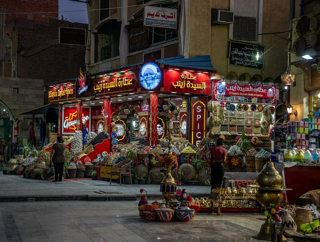 Khan El Khalili what to buy bazaar lit up at night with shoppers browsing lanterns