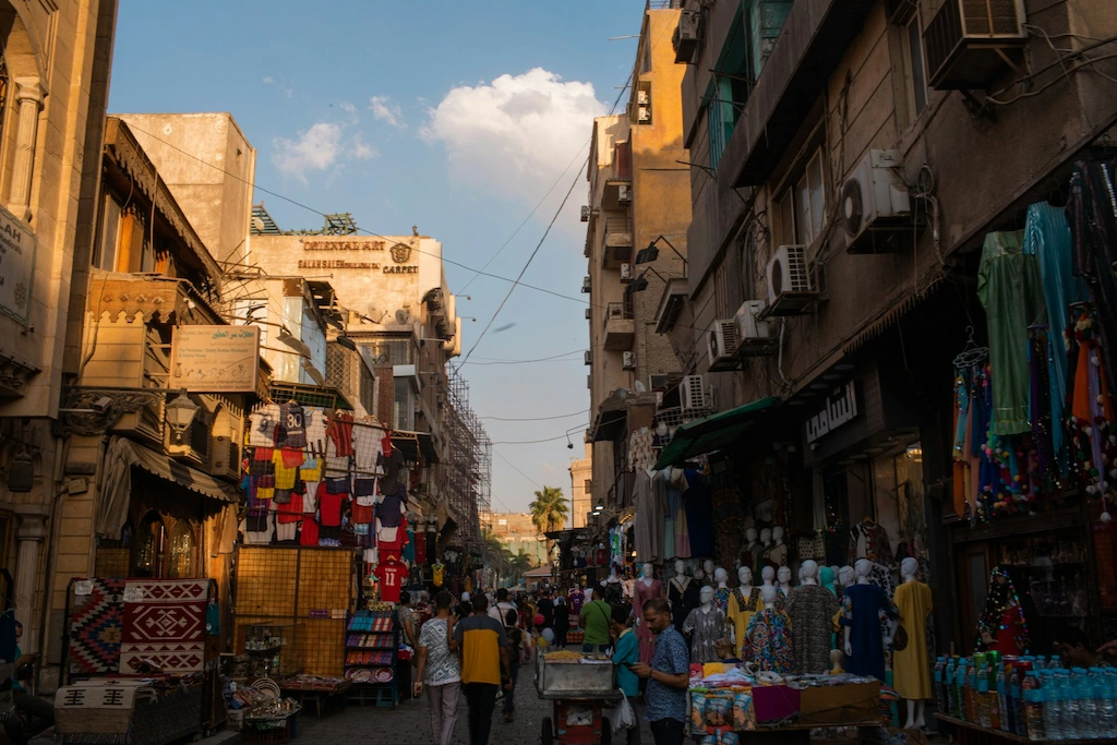 Shoppers walking through a textile lane in Khan El Khalili bazaar