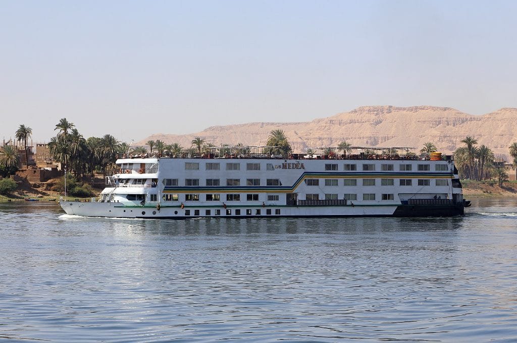 Nile cruise ship sailing near Luxor - the larger option in the dahabiyah vs Nile cruise choice