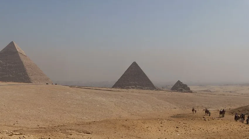 The three pyramids of Giza seen across the plateau