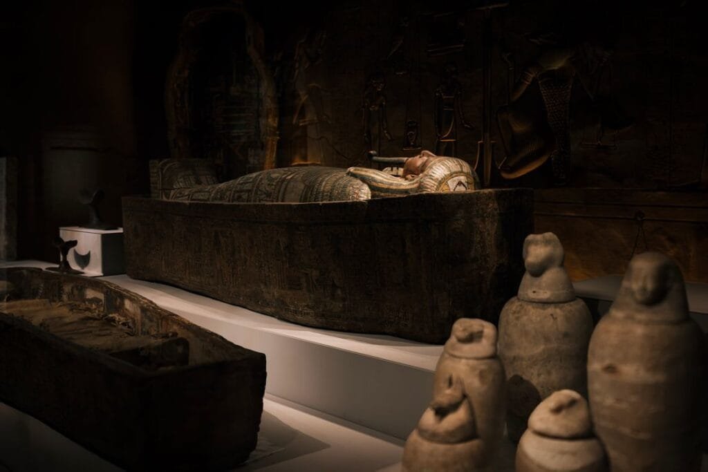 Canopic jars beside a sarcophagus, part of the what is mummification embalming process