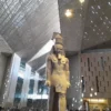 All Saints' Day holiday in Egypt: a Ramesses II statue standing in the Grand Egyptian Museum great hall