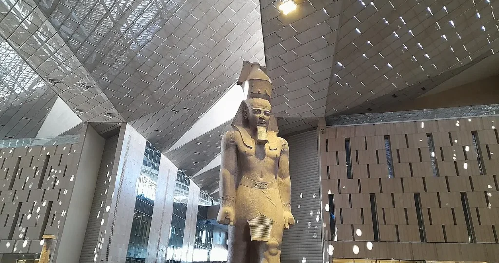 All Saints' Day holiday in Egypt: a Ramesses II statue standing in the Grand Egyptian Museum great hall