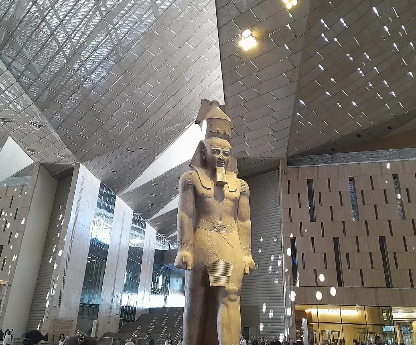All Saints' Day holiday in Egypt: a Ramesses II statue standing in the Grand Egyptian Museum great hall