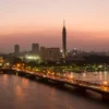 Cairo Tower and Qasr El Nil Bridge at dusk on the Nile