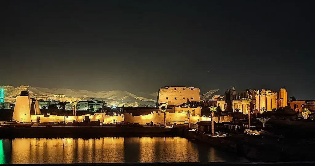 Christmas and New Year in Egypt: a floodlit Nile-side temple reflected in the water during an evening sound and light show