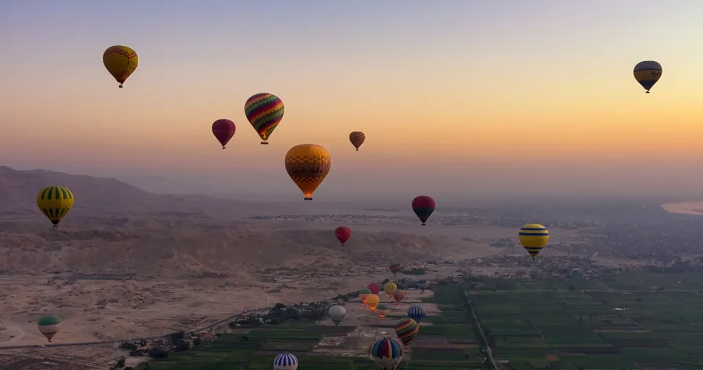 Christmas vacation ideas: hot air balloons rising over Luxor at sunrise