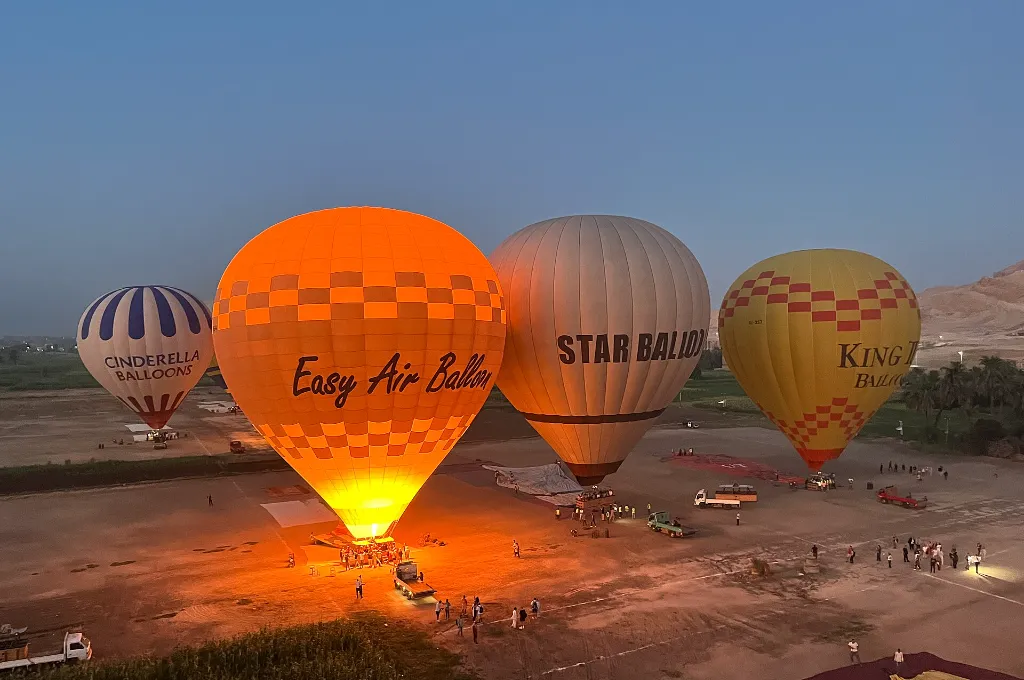 Montgolfières lumineuses à l'aube au-dessus de Louxor, un début magique d'escapade romantique à Noël en Égypte