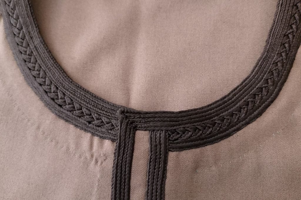 Braided and embroidered collar of a galabeya, a close-up of Egyptian traditional clothes