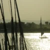 Sailboat masts on the Nile at dusk near Luxor