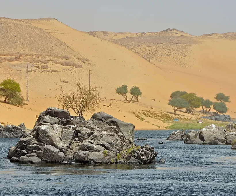 Warm Christmas vacations in Egypt: granite rocks and golden dunes along the sunlit Nile at Aswan
